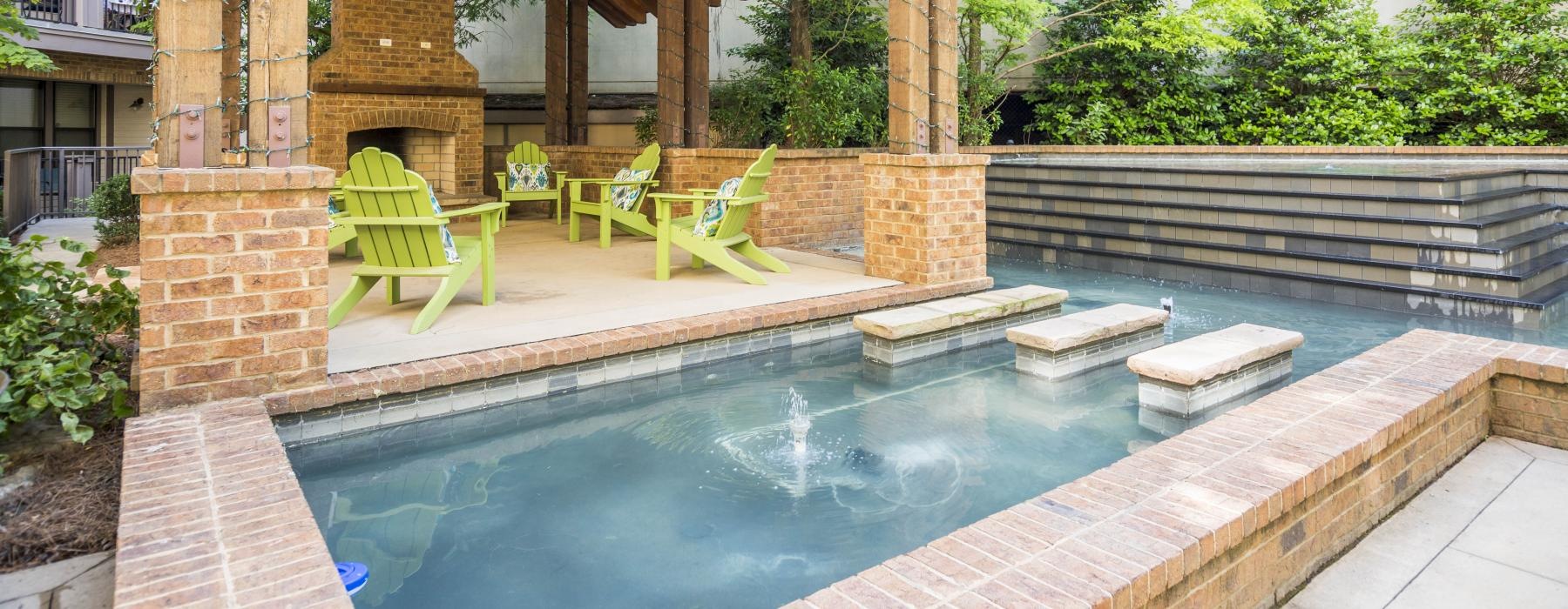 a pool or water with chairs and a covered patio